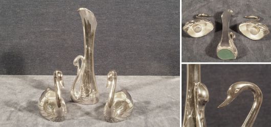Two candle holders and a small vase in the shape of swans